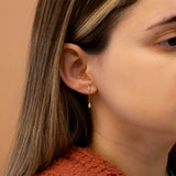 Model wears petite diamond chain stud earring with clover diamond cluster
