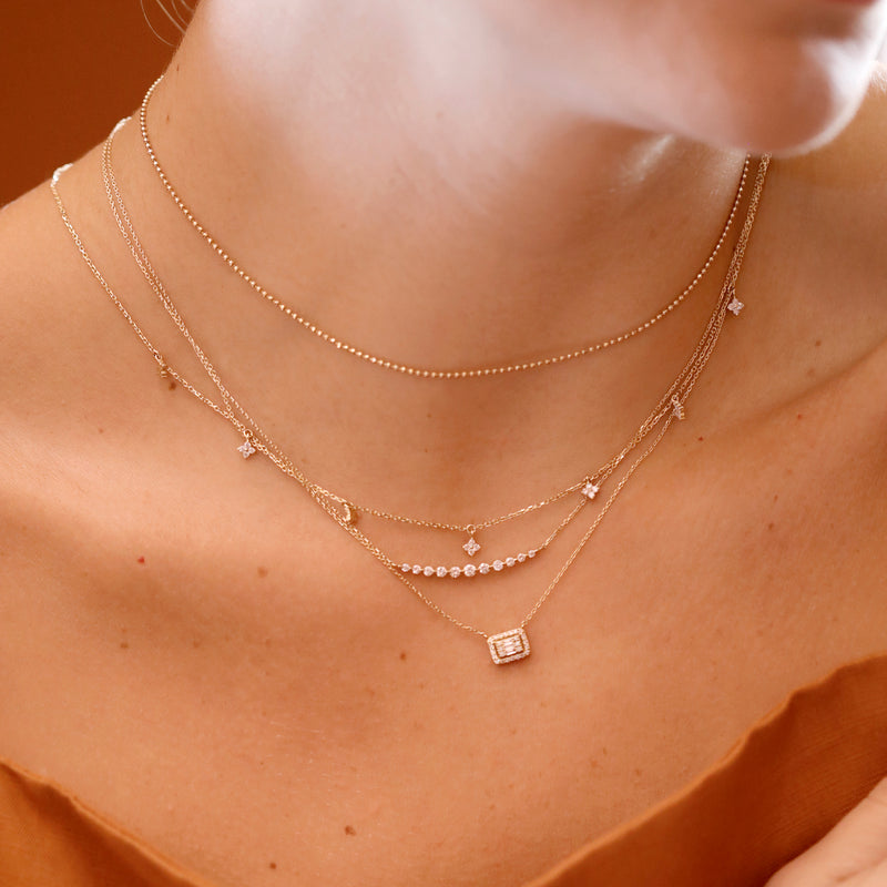 Necklace Layering with natural diamond charms and pendants in solid gold