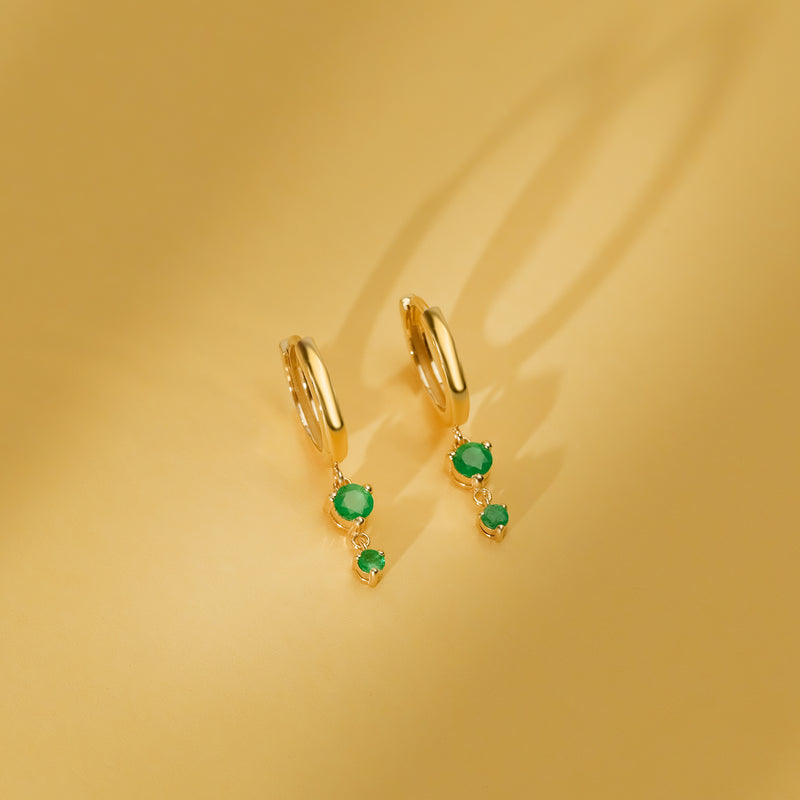 pair of minimalistic solid 14k gold drop earrings with two emerald stones