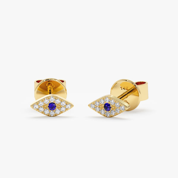 Handmade pair of solid 14k gold eye shape stud earrings in paved diamonds and single blue sapphire