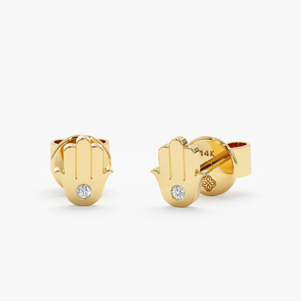 Handmade pair of solid 14k gold hamsa hand stud earrings with single diamond