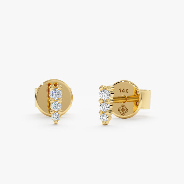 Handmade pair of solid 14k gold spike stud earrings with three set diamonds