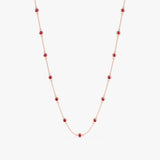 Multi ruby bezel set stations on a solid gold chain necklace.