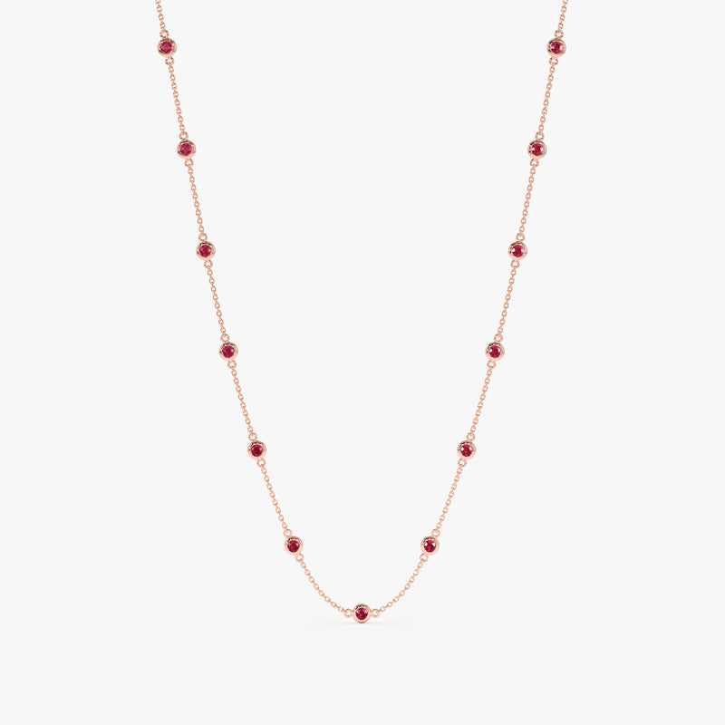 Multi ruby bezel set stations on a solid gold chain necklace.