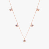 handcrafted solid rose gold necklace with multiple hanging eye charms in lined diamonds and blue sapphires