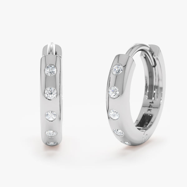 Handcrafted pair of solid white gold flush set diamond huggie earrings