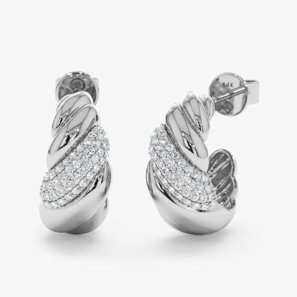 Pair of elegant handcrafted 14k solid white gold croissant style huggies with lined natural diamonds.