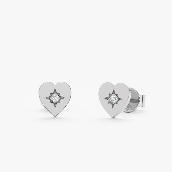 Handcrafted pair of solid white gold heart shape stud earrings with single white diamond