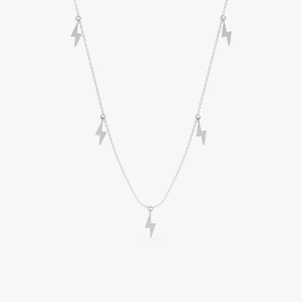 Solid gold necklace featuring five dangling lightning bolt charms.