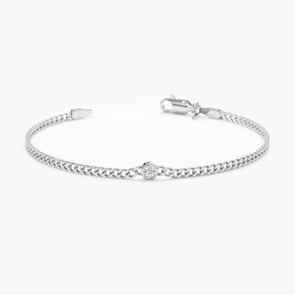 Solid white gold Cuban chain bracelet featuring a sparkling solitaire diamond.