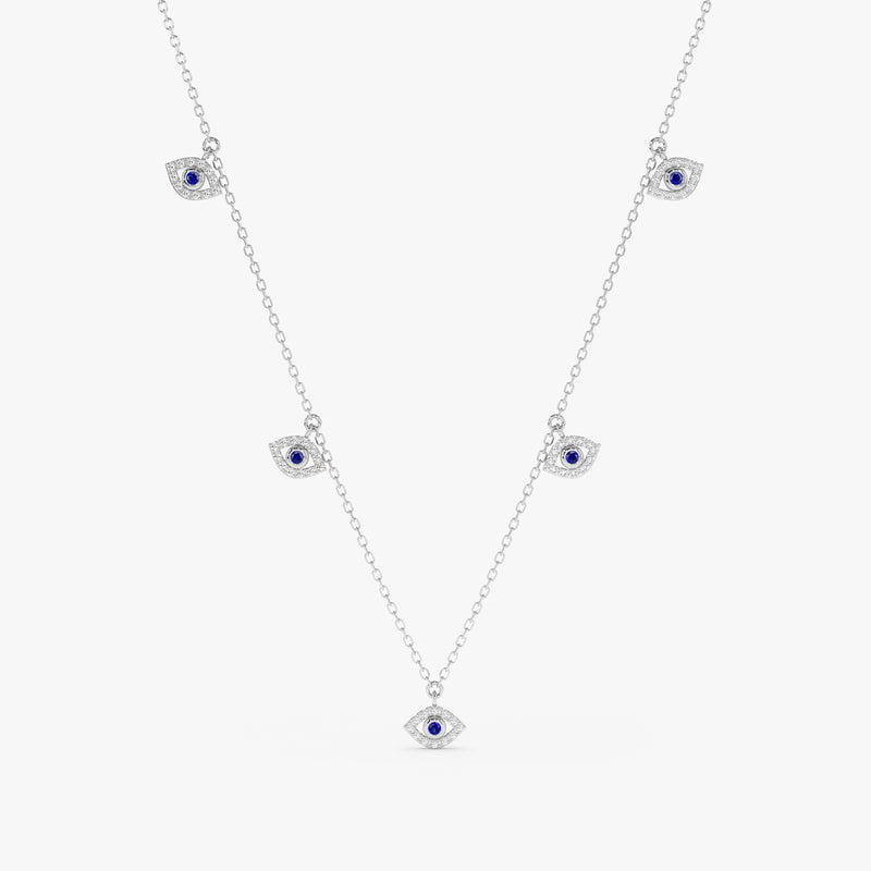 handmade solid white gold necklace with hanging eye charms in white diamonds and blue sapphire