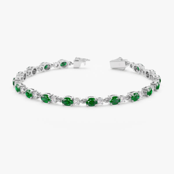 tennis bracelet with alternating diamonds and emeralds in white gold