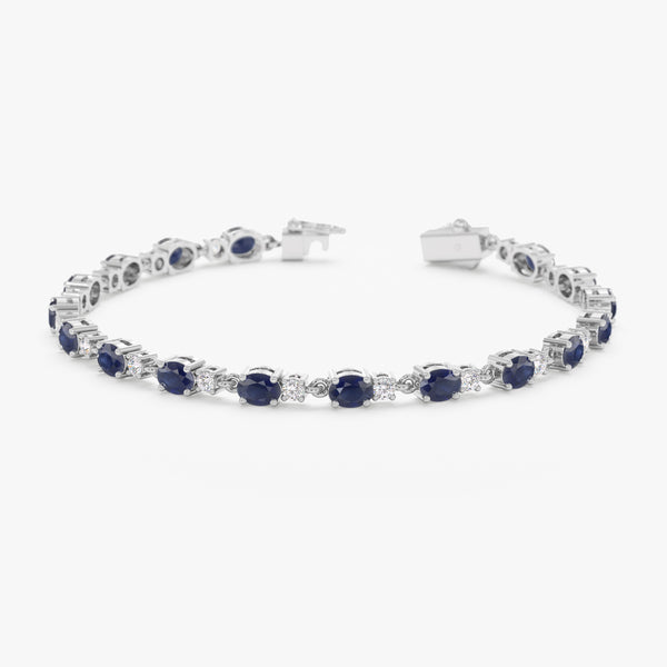 18k white gold garland bracelet adorned with genuine sapphires and diamonds.