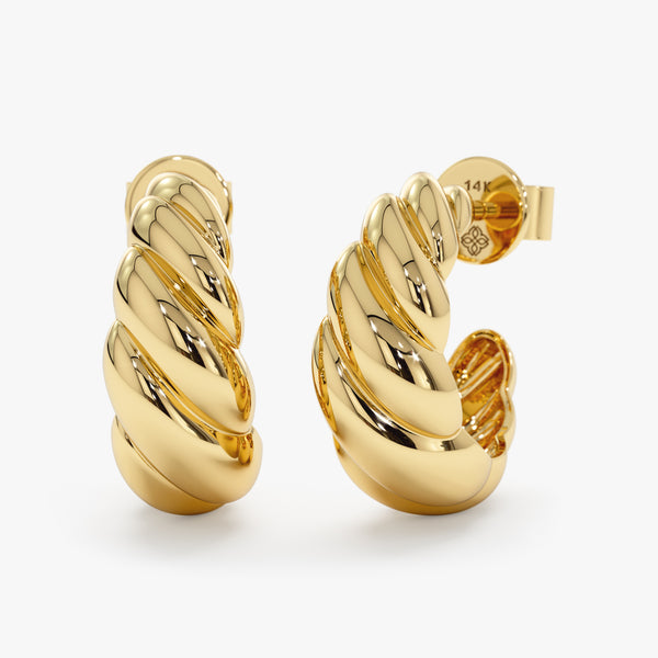 Pair of thick handcrafted 14k solid gold croissant twisted ear huggies.