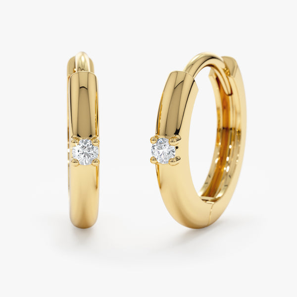 Handmade pair of solid 14k gold hoop huggies with single diamond setting
