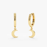 Pair of handmade crescent moon charm huggies in 14k solid gold. 