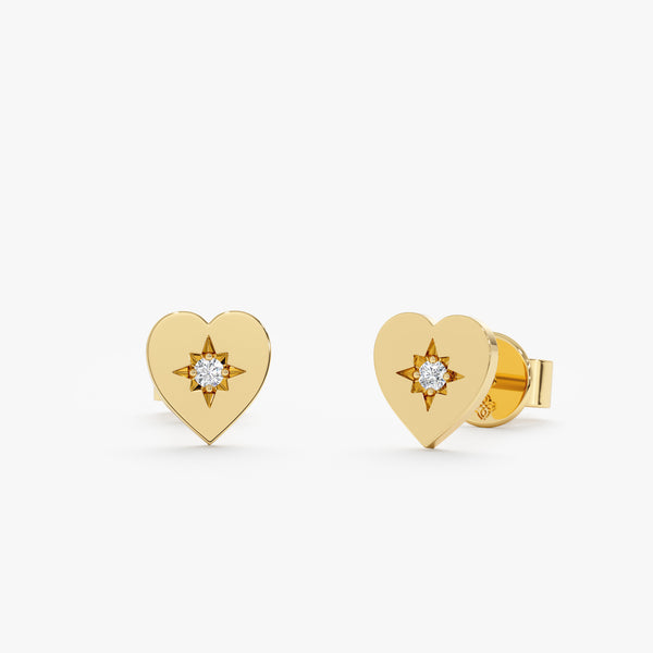 Handmade pair of solid 14k yellow gold heart shape stud earrings with single diamond in the middle