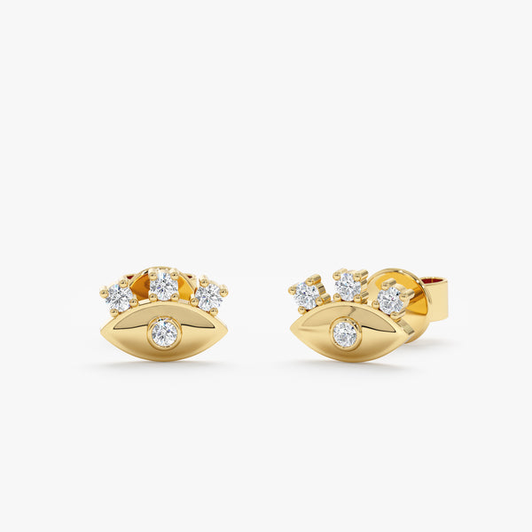 handmade pair of solid 14k gold eye stud earrings with diamond eyelashes 
