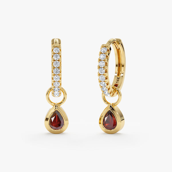 Pair of pear cut ruby huggies lined in diamonds in 14k solid gold