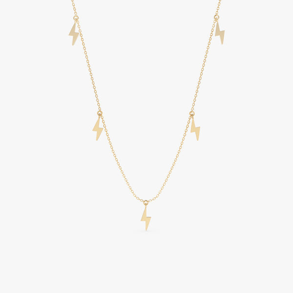 Lightning bolt drop necklace in gold with five polished lightning bolt charms.