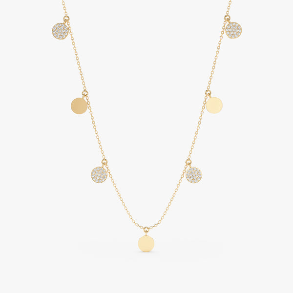 Gold mixed coin drop necklace with alternating smooth gold disks and diamond-studded disks.