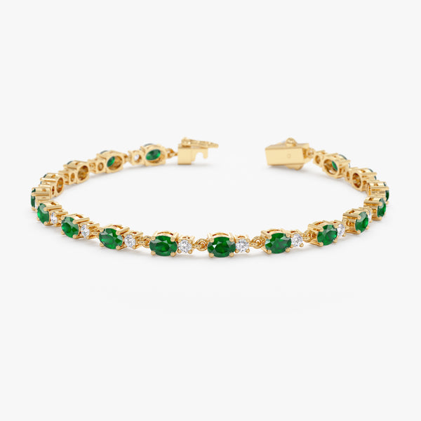 Diamond and emerald tennis bracelet in gold