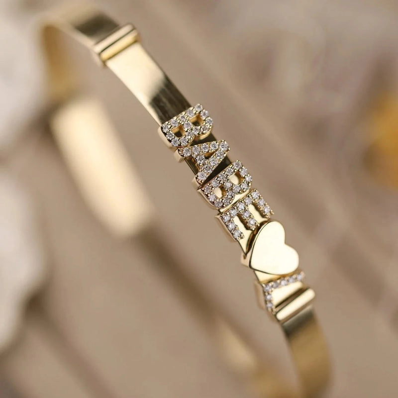 Gold charm bangle with plenty of options.