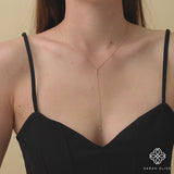 Solid gold lariat necklace featuring a slender bar pendant with a diamond accent