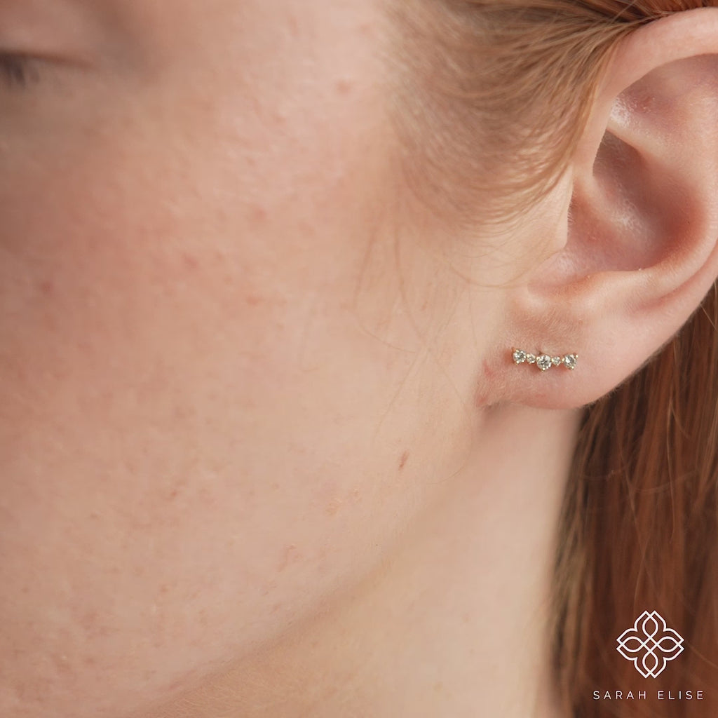 Video close up of handmade ethically sourced curved bar earring stud with multiple diamonds