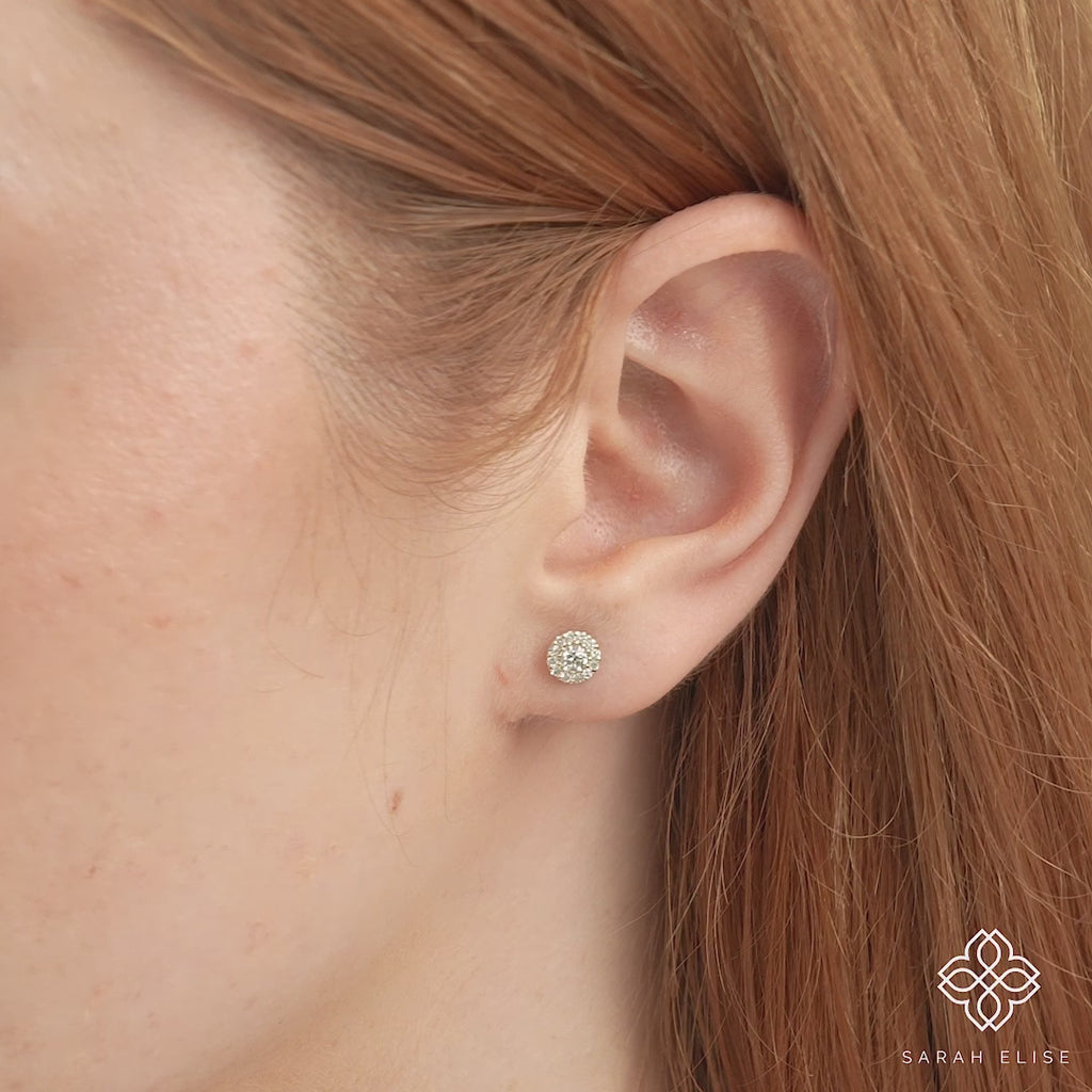 Video close up of model wearing petite classic diamond stud earrings