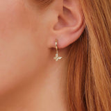 Model wears Dangly Diamond Butterfly Huggies with natural diamonds April birthstone in solid 14k gold