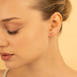 Model wears Tiny Gold Aquamarine Huggie hoop Earrings