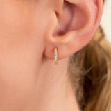 Model wears Solid Gold Diamond Huggie hoop earrings for her