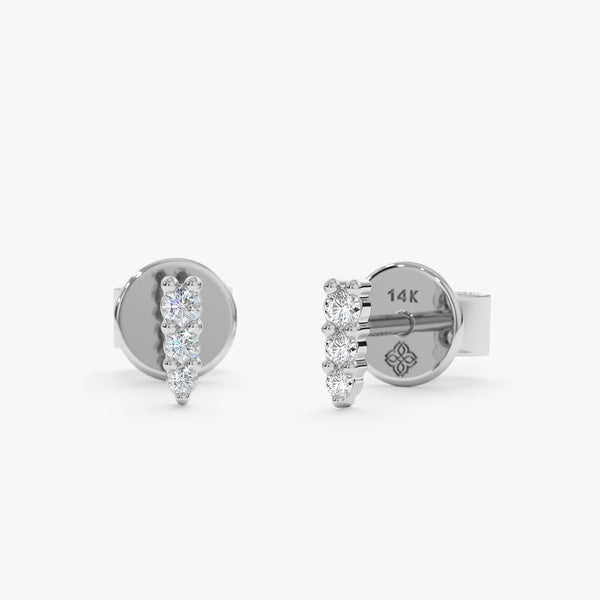 handcrafted pair of solid 14k solid white gold spike stud earrings with three set diamonds