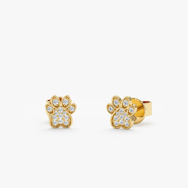 Handmade pair of solid 14k gold dog paw stud earrings filled with diamonds