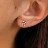 Model wearing stunning diamond snowflake stud earrings in 14k solid gold, radiating elegance.