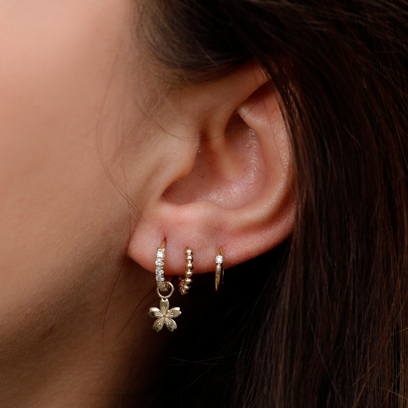 cherry blossom earring charm on a diamond huggie, beaded hoop and single diamond hoop