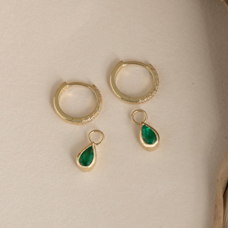 handmade solid gold diamond hoops with emerald charms