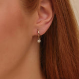 Model wears White Diamond Hoop Earrings with David Star Charm