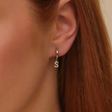 Model wears dainty handmade Natural Diamond Initial Hoop Earring 