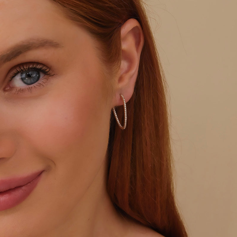 Model wears april birthstone clear diamond wavy hoop earring gift for her