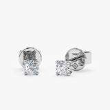 Essential pair of natural diamond 4 prong set ear studs in 14k solid white gold. 