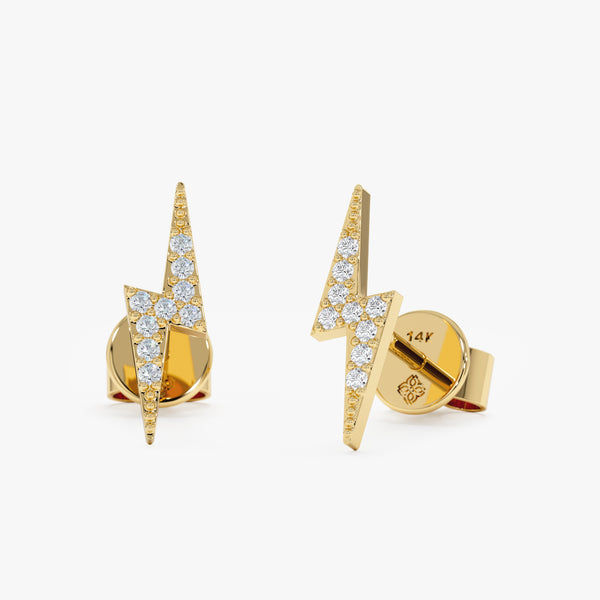 handmade pair of solid 14k gold lightning bolt stud earrings with paved diamonds