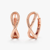 Dainty solid 14k rose gold hoops in curved infinity symbol shape. 