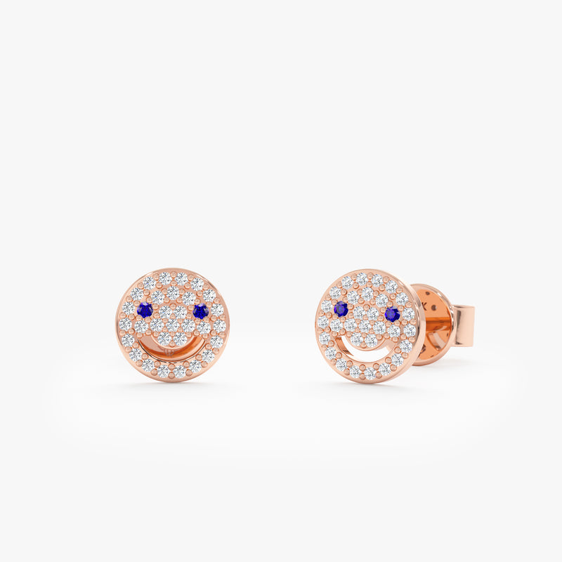 ethically sourced solid 14k rose gold smiley face stud earrings with paved diamonds and blue sapphires