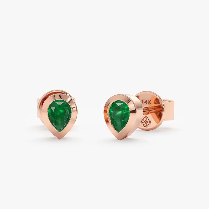 Pair of solid 14k rose gold earring studs with pear cut emerald stone. 