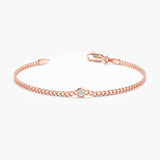 Stylish rose gold Cuban link bracelet with a single diamond.