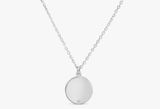 custom white gold disc pendant with single diamond