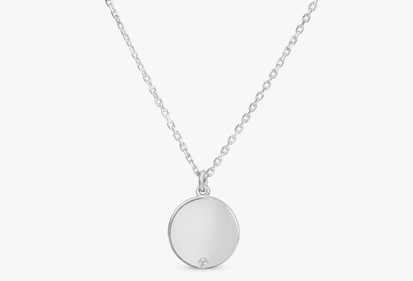 custom white gold disc pendant with single diamond