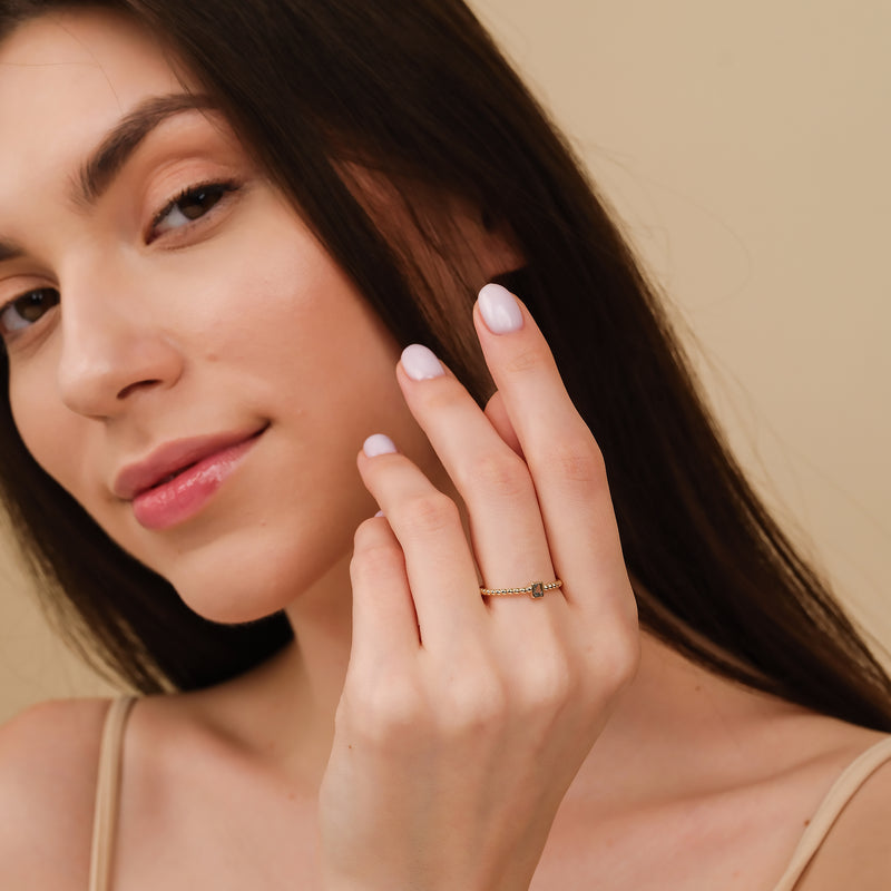 gold beaded ring with baguette aquamarine